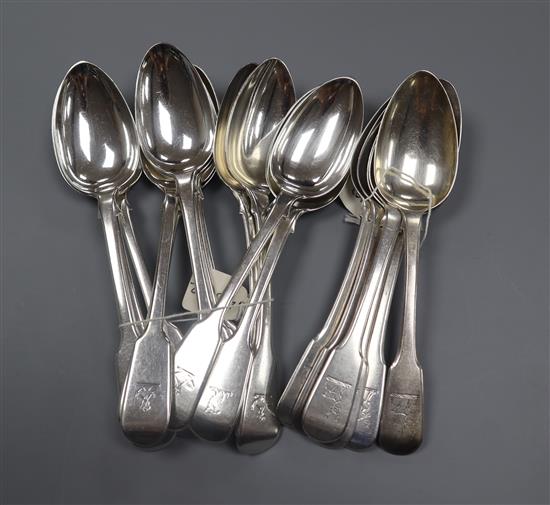 A set of six George III silver dessert fiddle pattern dessert spoons, London, 1814 and a harlequin set of twelve similar spoons.